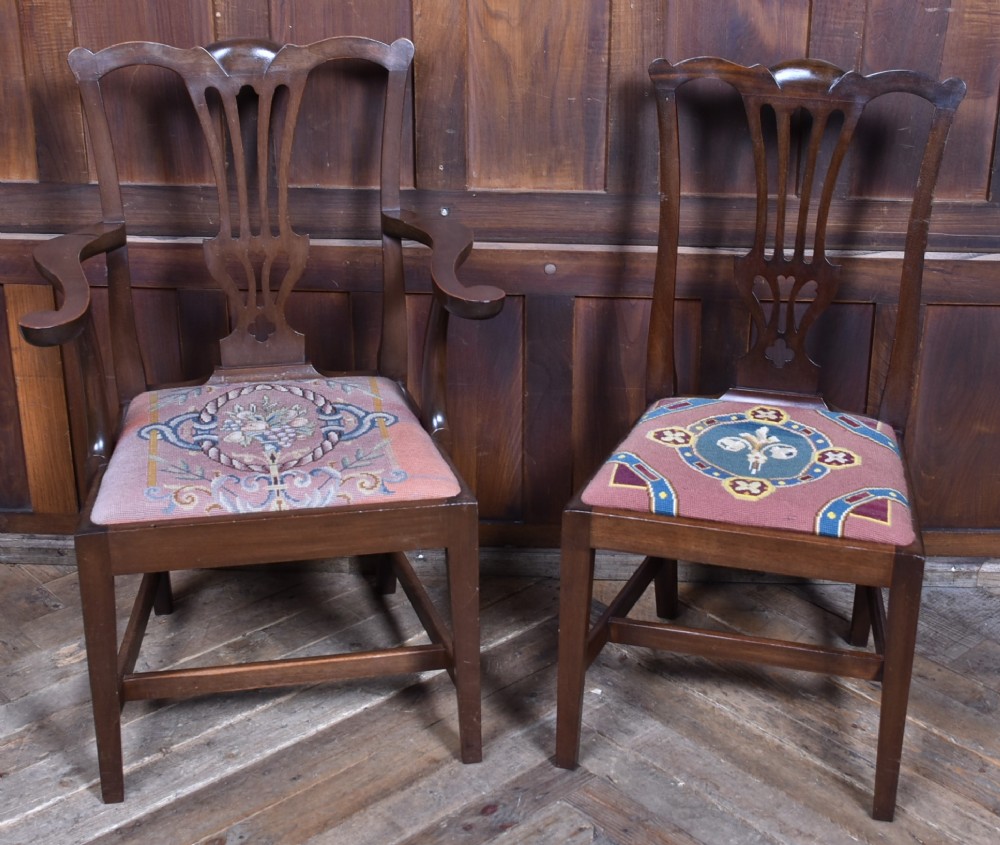 A set of ten dark brown wood dining chairs featuring carved pierced splat backs and patterned drop-in upholstered seats. View XIV
