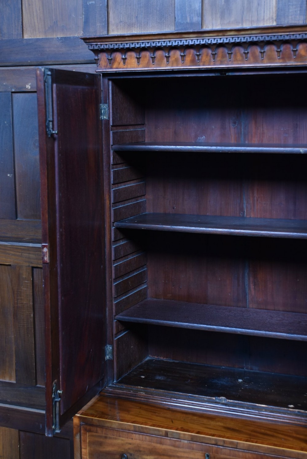 A tall Georgian mahogany secretaire bookcase featuring an upper two-door cabinet with oval inlay panels above a lower chest with four drawers and brass swan-neck handles. View VI