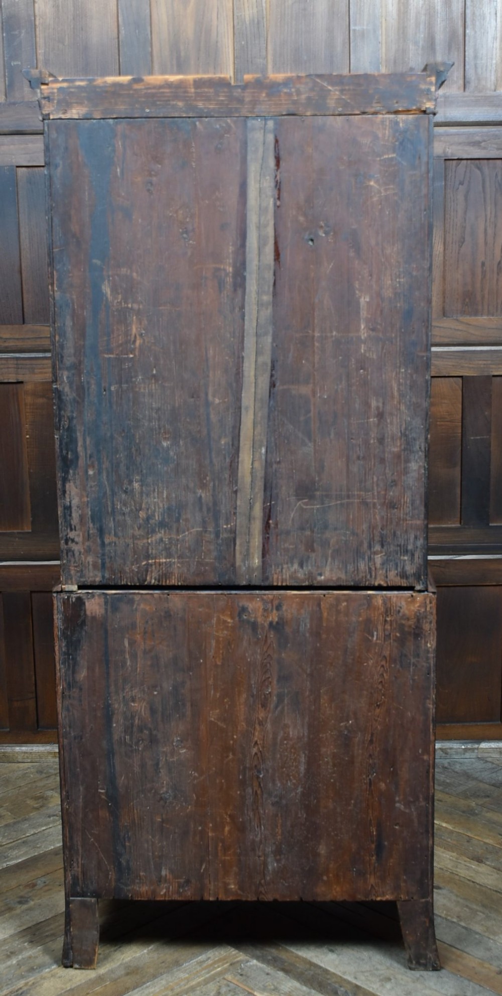 A tall Georgian mahogany secretaire bookcase featuring an upper two-door cabinet with oval inlay panels above a lower chest with four drawers and brass swan-neck handles. View X
