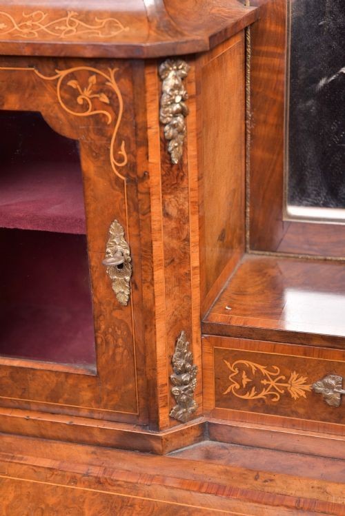 An antique French walnut ladys writing desk featuring floral marquetry, cabriole legs, brass mounts, and a raised upper section with glass cabinets and a central mirror. View VI