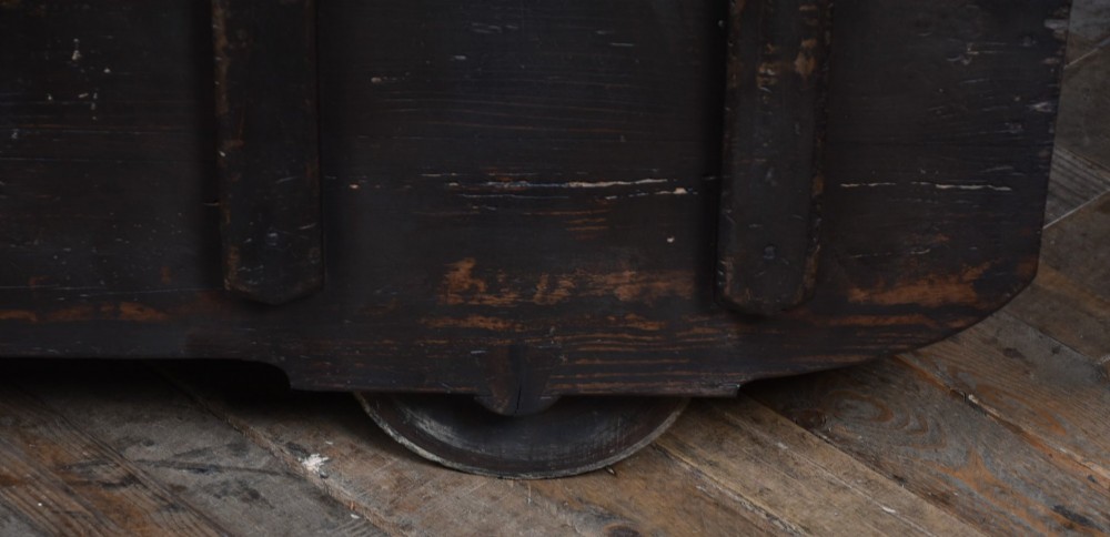 A dark brown Japanese wooden storage chest set on small wheels with vertical timber battens and hand-forged iron fittings. View IV