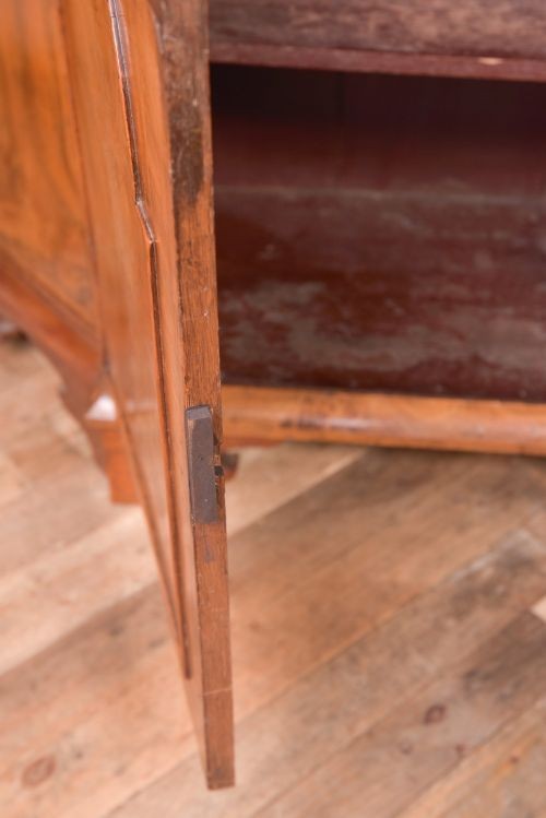 A nineteenth-century Dutch walnut display cabinet featuring a glazed upper section with individual glass panes and a lower cupboard with arched panelled doors resting on bracket feet. View VI