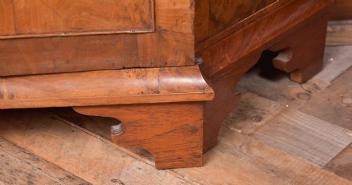 A nineteenth-century Dutch walnut display cabinet featuring a glazed upper section with individual glass panes and a lower cupboard with arched panelled doors resting on bracket feet. View XIV