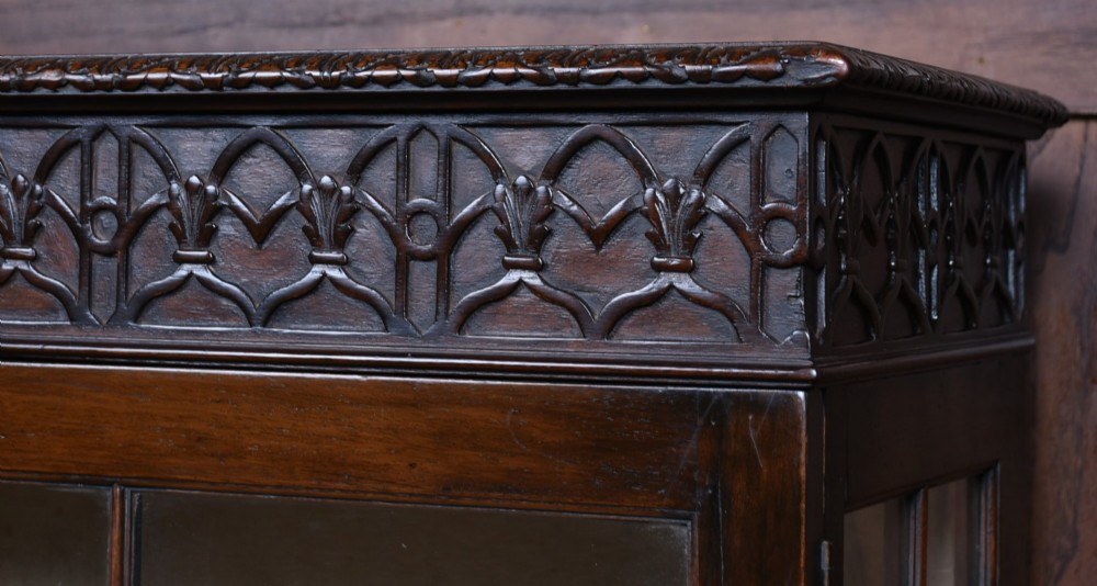 A dark mahogany Chippendale Revival display cabinet featuring double glazed doors with diamond astragal glazing, blind fretwork frieze, and cabriole legs on ball and claw feet. View III