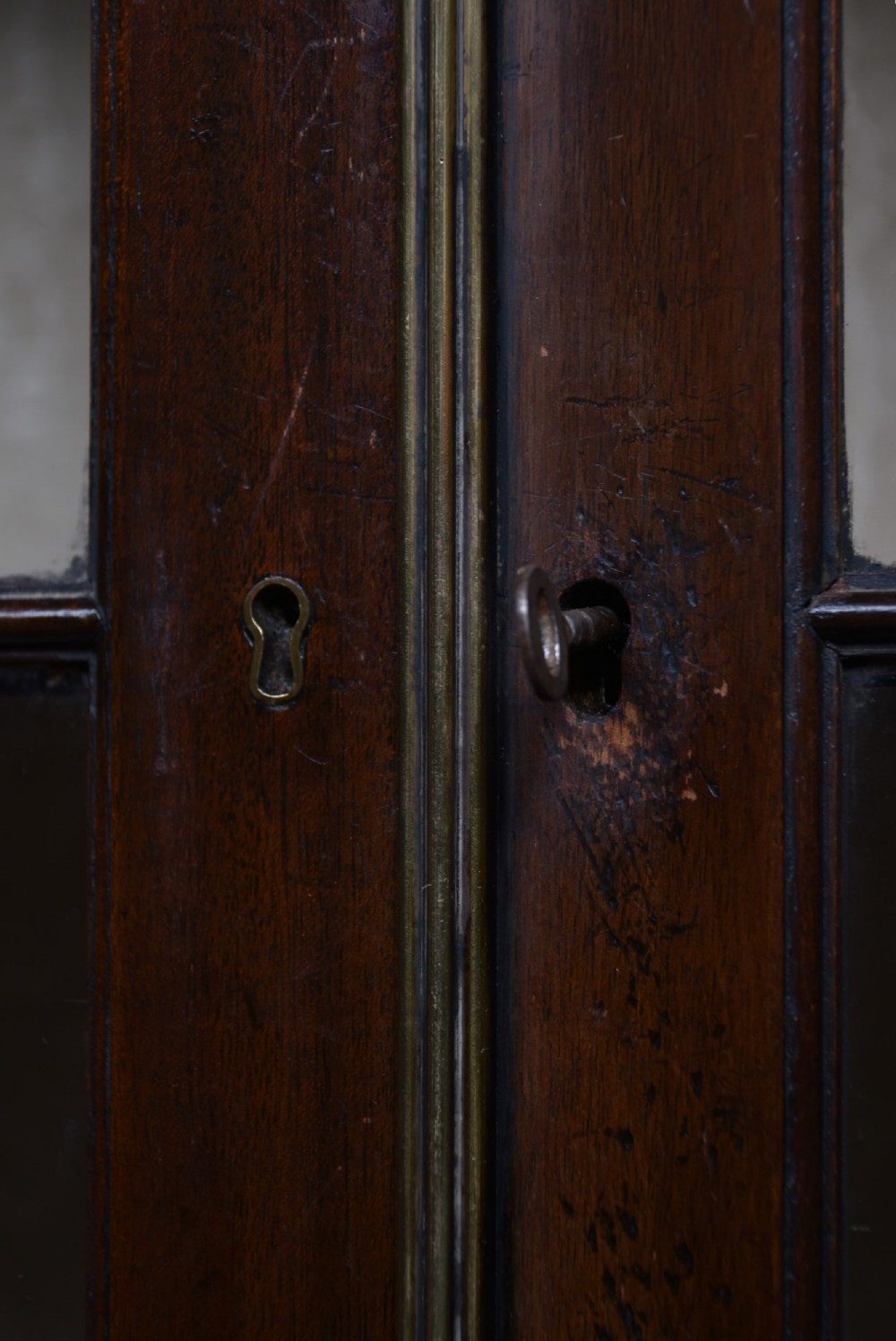 A dark mahogany Chippendale Revival display cabinet featuring double glazed doors with diamond astragal glazing, blind fretwork frieze, and cabriole legs on ball and claw feet. View IV