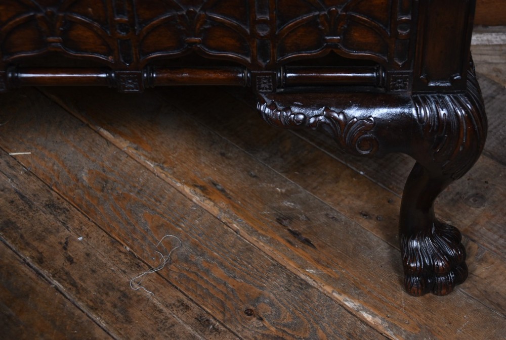 A dark mahogany Chippendale Revival display cabinet featuring double glazed doors with diamond astragal glazing, blind fretwork frieze, and cabriole legs on ball and claw feet. View V