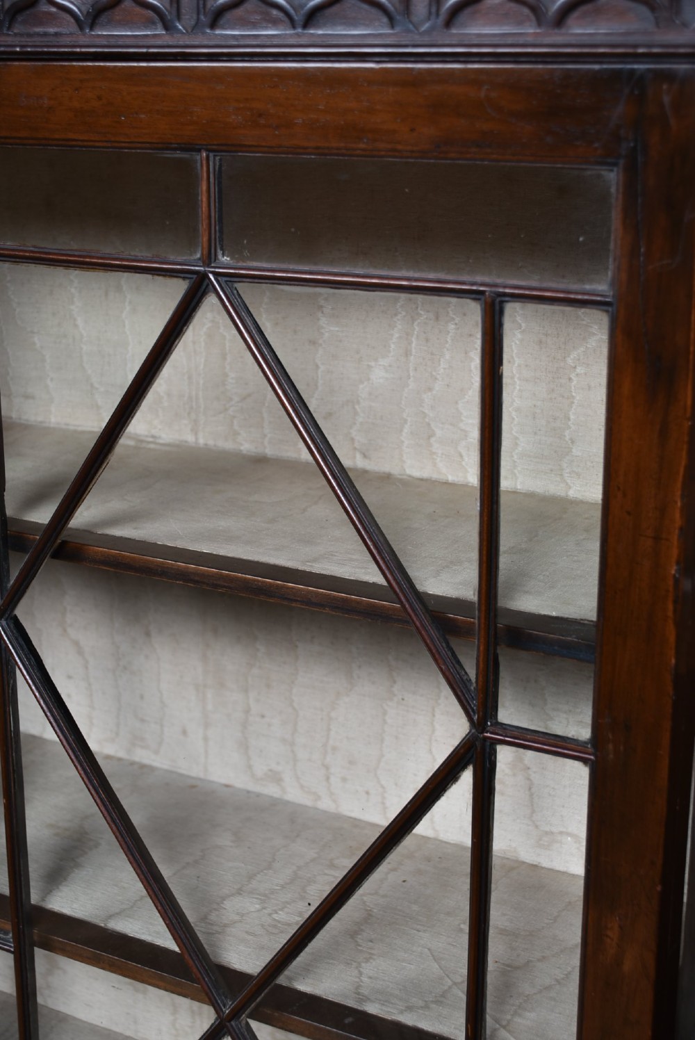A dark mahogany Chippendale Revival display cabinet featuring double glazed doors with diamond astragal glazing, blind fretwork frieze, and cabriole legs on ball and claw feet. View VII