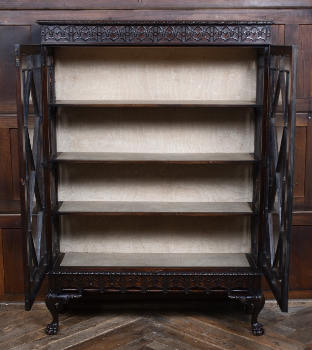 A dark mahogany Chippendale Revival display cabinet featuring double glazed doors with diamond astragal glazing, blind fretwork frieze, and cabriole legs on ball and claw feet. View VIII