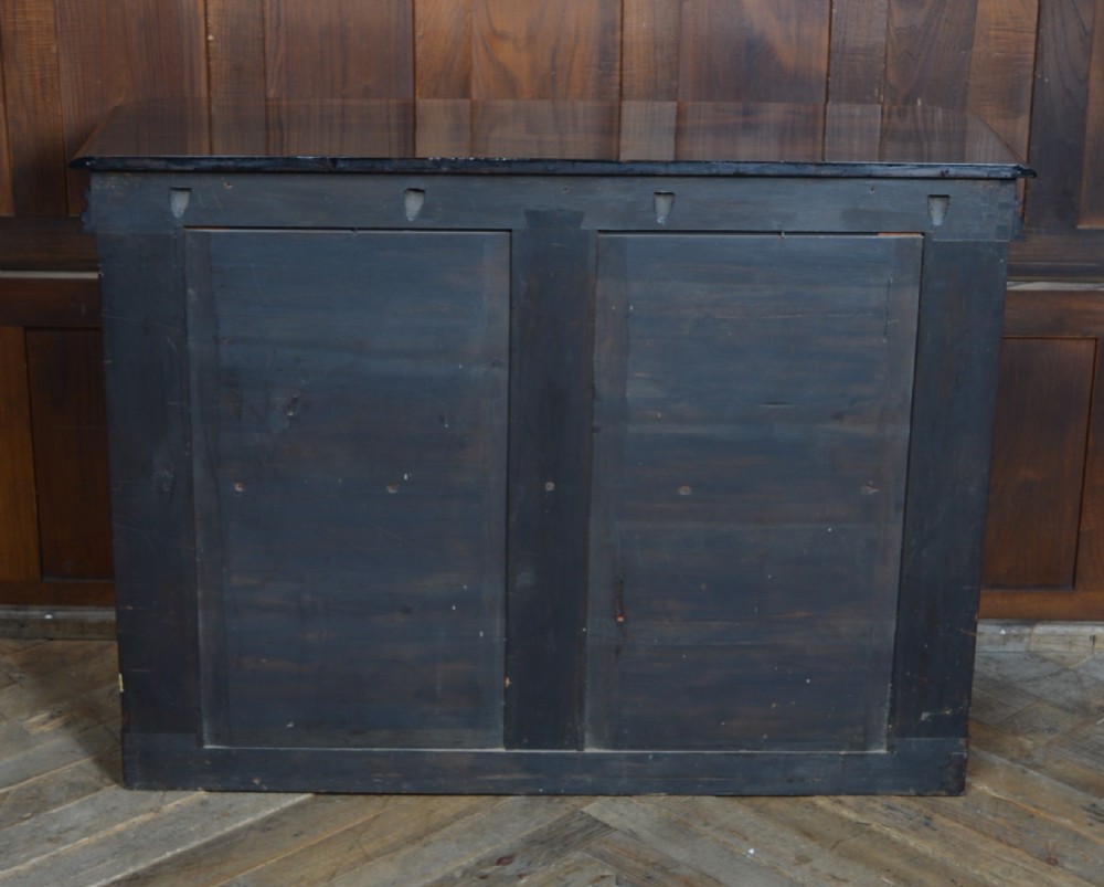 A dark Victorian rosewood console table featuring carved S-scroll supports, an open central shelf, a beaded upper frieze, and a solid plinth base. View IX