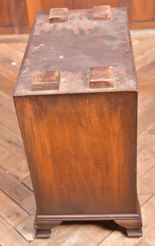 An Edwardian walnut pedestal desk featuring nine drawers with brass swan-neck handles, panelled sides, and bracket feet. View X