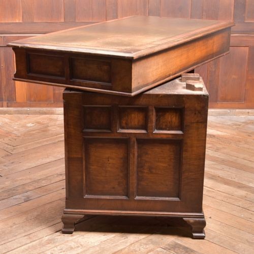 An Edwardian walnut pedestal desk featuring nine drawers with brass swan-neck handles, panelled sides, and bracket feet. View XIV