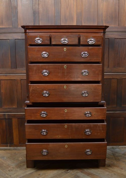 A Georgian mahogany chest-on-chest featuring two stacked drawer units with brass handles and bracket feet. View V