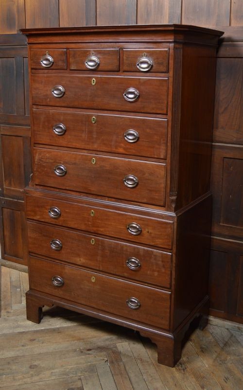 A Georgian mahogany chest-on-chest featuring two stacked drawer units with brass handles and bracket feet. View VII