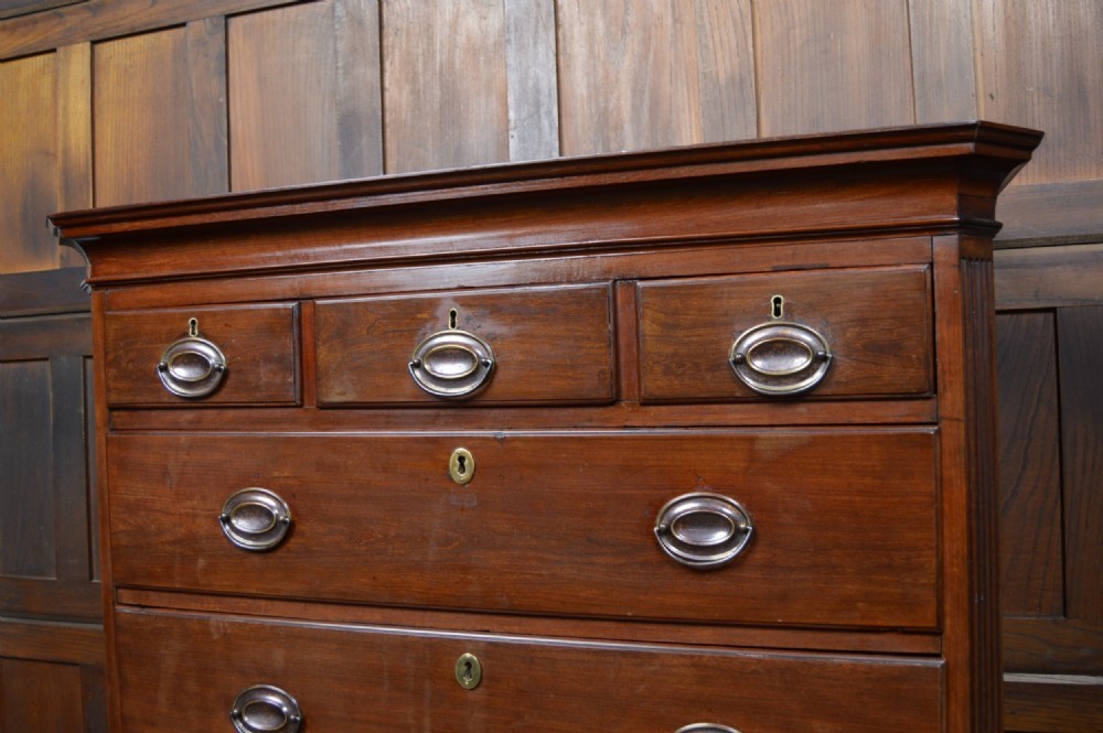 A Georgian mahogany chest-on-chest featuring two stacked drawer units with brass handles and bracket feet. View VIII