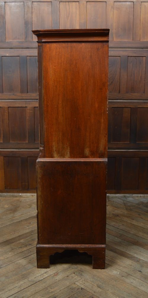 A Georgian mahogany chest-on-chest featuring two stacked drawer units with brass handles and bracket feet. View X