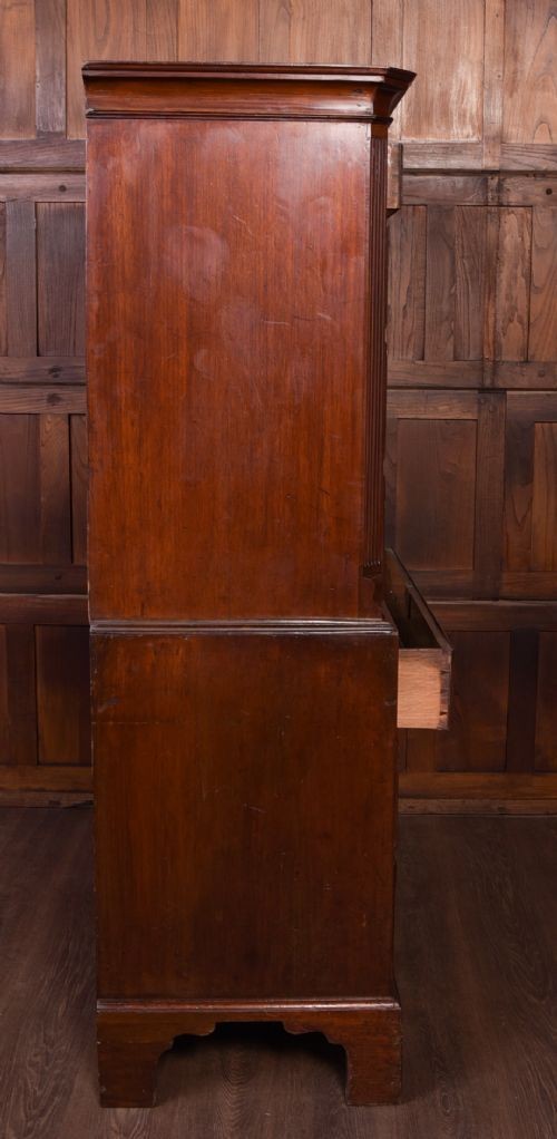 A Georgian mahogany chest-on-chest featuring two stacked drawer units with brass handles and bracket feet. View XI