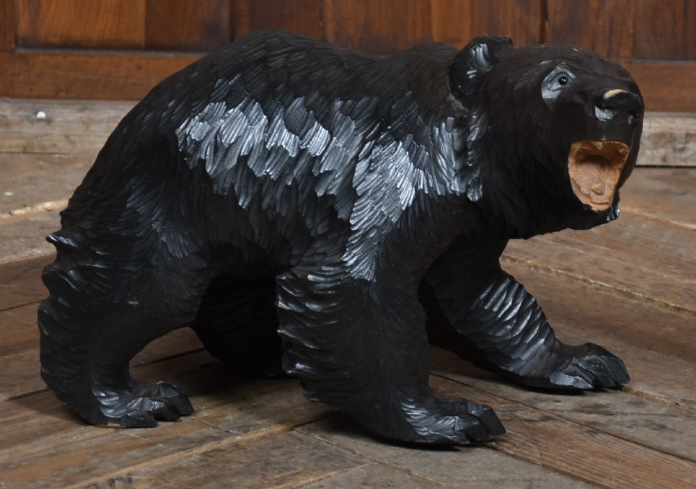 A hand-carved dark wood Japanese Kibori Kuma bear sculpture depicting a standing bear with an open mouth showing carved teeth and textured fur detailing.