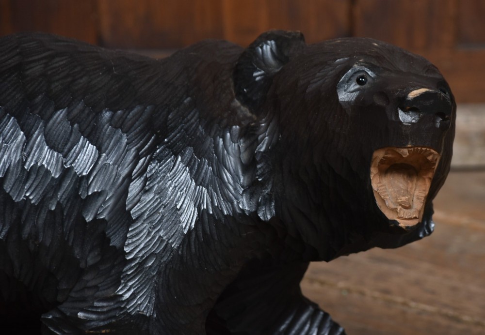 A hand-carved dark wood Japanese Kibori Kuma bear sculpture depicting a standing bear with an open mouth showing carved teeth and textured fur detailing. View II