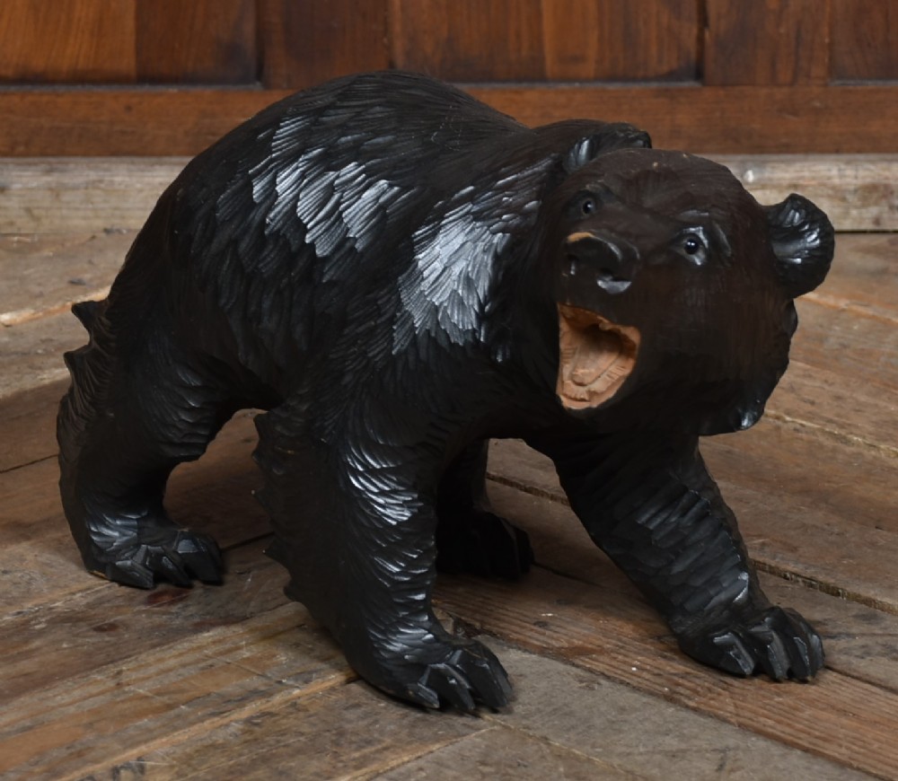 A hand-carved dark wood Japanese Kibori Kuma bear sculpture depicting a standing bear with an open mouth showing carved teeth and textured fur detailing. View III