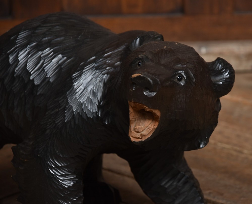 A hand-carved dark wood Japanese Kibori Kuma bear sculpture depicting a standing bear with an open mouth showing carved teeth and textured fur detailing. View IV