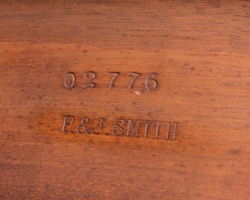 A Victorian mahogany extendable dining table featuring turned legs on brass castors, rounded tabletop corners, and an exposed metal winding crank handle. View V