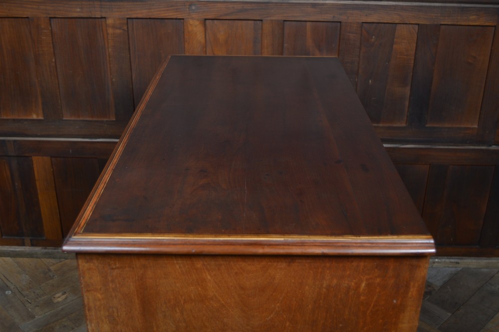 A Regency mahogany secretaire chest featuring oval inlay on the top drawer, brass oval handles, bone escutcheons, and splayed bracket feet. View XI