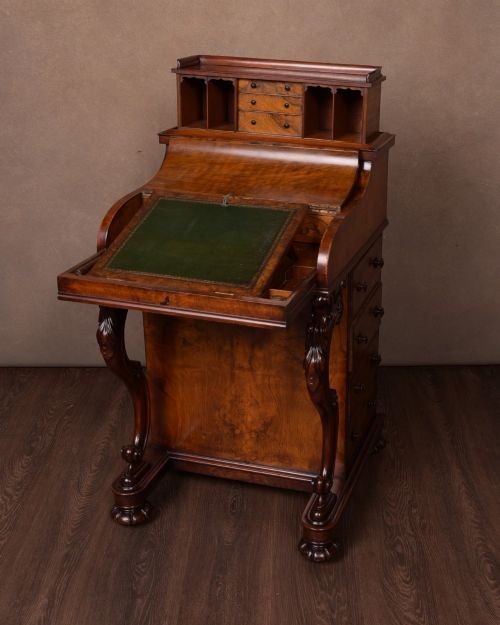 A Victorian burr walnut pop-up Davenport desk featuring carved scroll front supports, side drawers with wooden knobs, and a hinged sloping top. View II