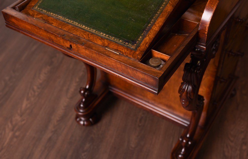 A Victorian burr walnut pop-up Davenport desk featuring carved scroll front supports, side drawers with wooden knobs, and a hinged sloping top. View V