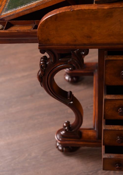 A Victorian burr walnut pop-up Davenport desk featuring carved scroll front supports, side drawers with wooden knobs, and a hinged sloping top. View VII