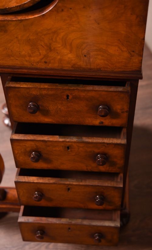 A Victorian burr walnut pop-up Davenport desk featuring carved scroll front supports, side drawers with wooden knobs, and a hinged sloping top. View VIII