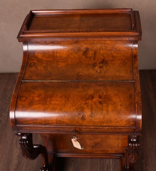 A Victorian burr walnut pop-up Davenport desk featuring carved scroll front supports, side drawers with wooden knobs, and a hinged sloping top. View XII
