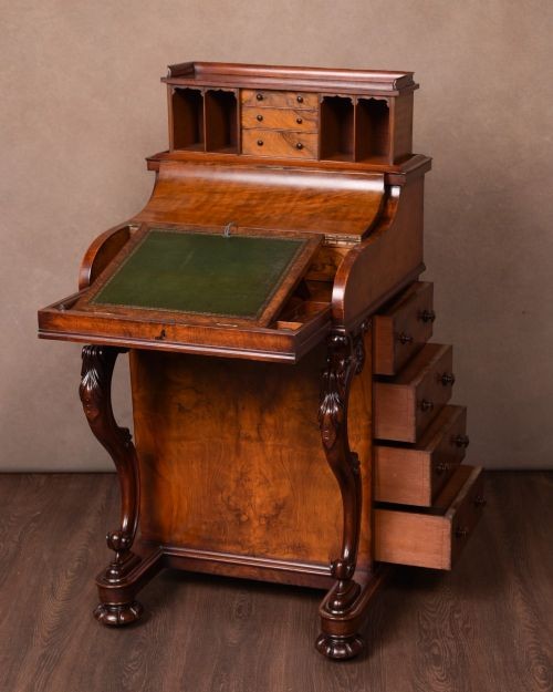 A Victorian burr walnut pop-up Davenport desk featuring carved scroll front supports, side drawers with wooden knobs, and a hinged sloping top. View XIII