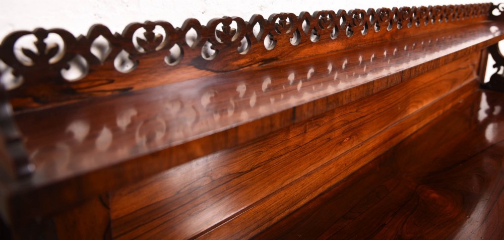 A 19th-century rosewood breakfront side cabinet featuring rich grain panels, carved accents, and a pierced top gallery rail. View II