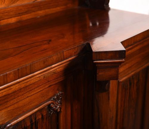 A 19th-century rosewood breakfront side cabinet featuring rich grain panels, carved accents, and a pierced top gallery rail. View IV