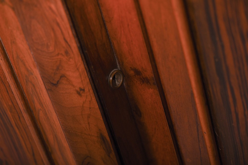 A 19th-century rosewood breakfront side cabinet featuring rich grain panels, carved accents, and a pierced top gallery rail. View VII