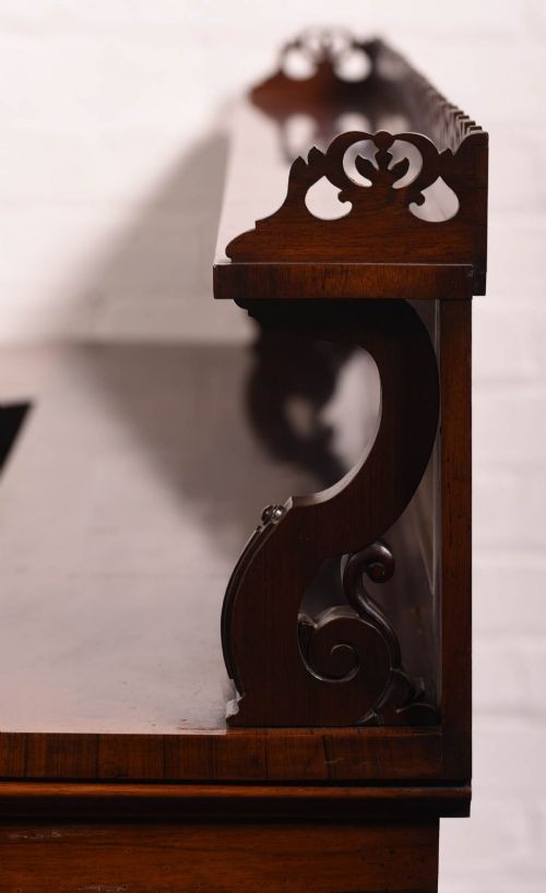 A 19th-century rosewood breakfront side cabinet featuring rich grain panels, carved accents, and a pierced top gallery rail. View VIII