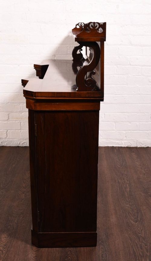 A 19th-century rosewood breakfront side cabinet featuring rich grain panels, carved accents, and a pierced top gallery rail. View IX