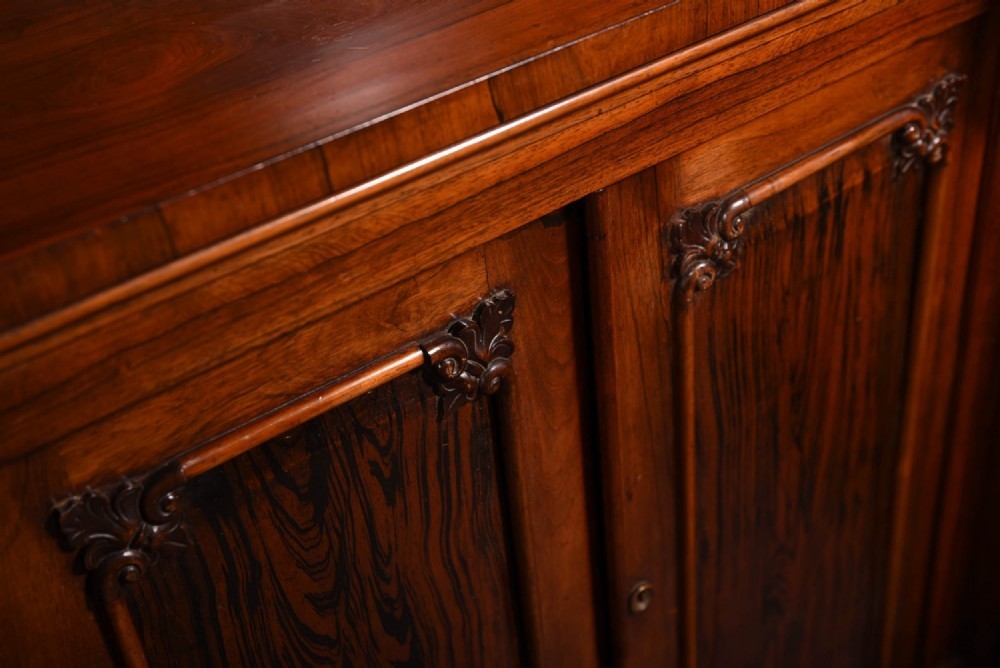 A 19th-century rosewood breakfront side cabinet featuring rich grain panels, carved accents, and a pierced top gallery rail. View XI