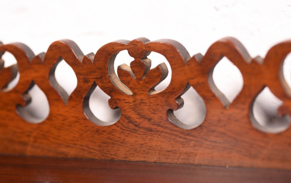 A 19th-century rosewood breakfront side cabinet featuring rich grain panels, carved accents, and a pierced top gallery rail. View XII