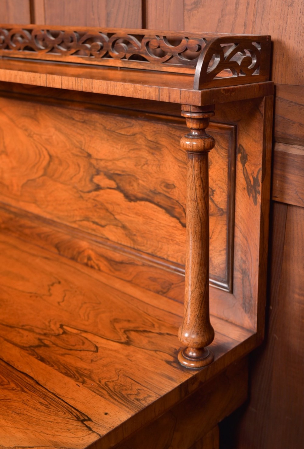 A Victorian rosewood chiffonier side cabinet featuring a raised back shelf with open fretwork gallery, turned columns, and a double-door cupboard base. View II