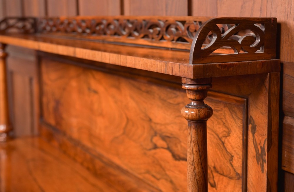 A Victorian rosewood chiffonier side cabinet featuring a raised back shelf with open fretwork gallery, turned columns, and a double-door cupboard base. View III