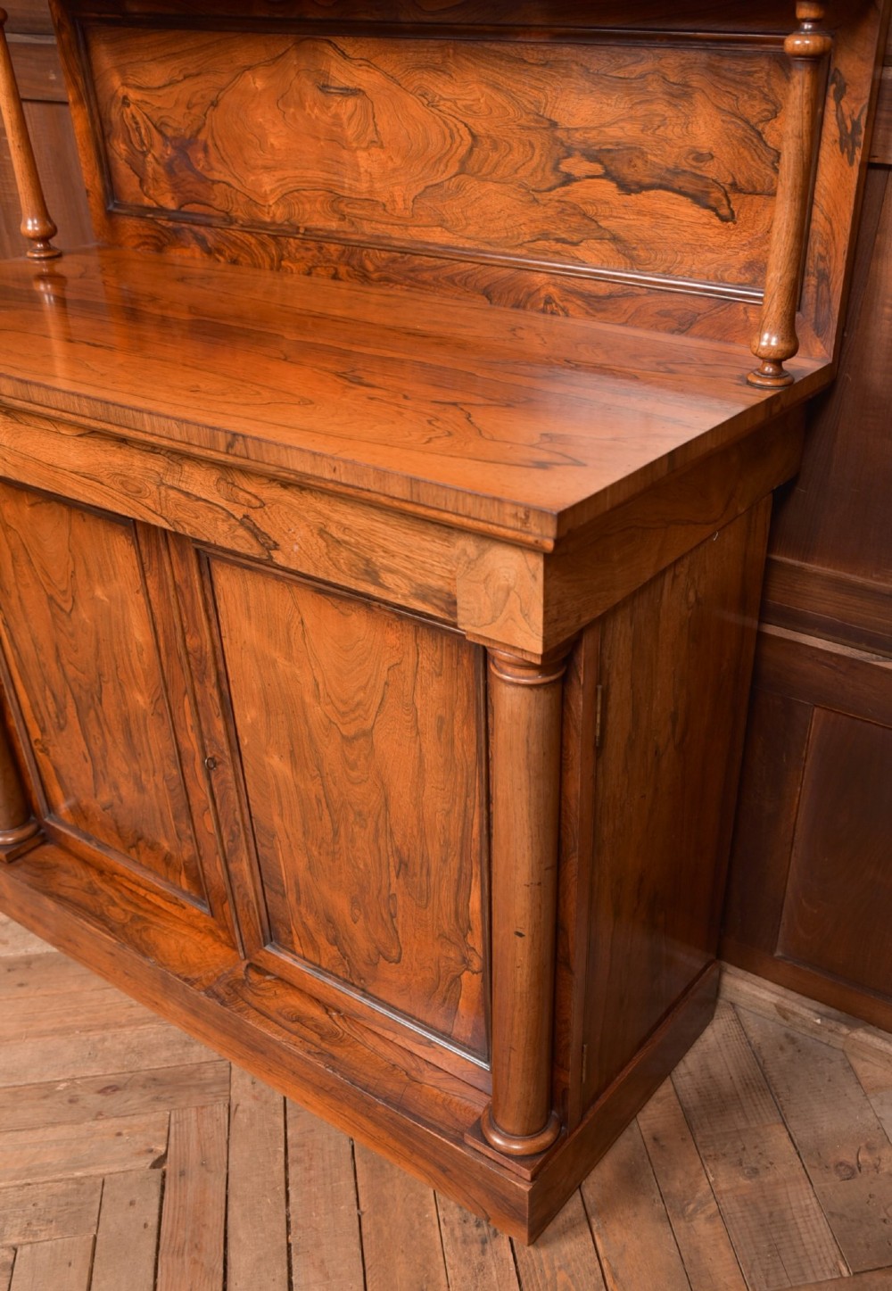 A Victorian rosewood chiffonier side cabinet featuring a raised back shelf with open fretwork gallery, turned columns, and a double-door cupboard base. View VII