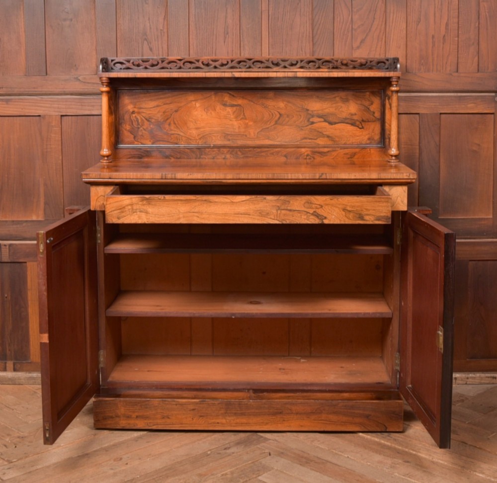 A Victorian rosewood chiffonier side cabinet featuring a raised back shelf with open fretwork gallery, turned columns, and a double-door cupboard base. View VIII