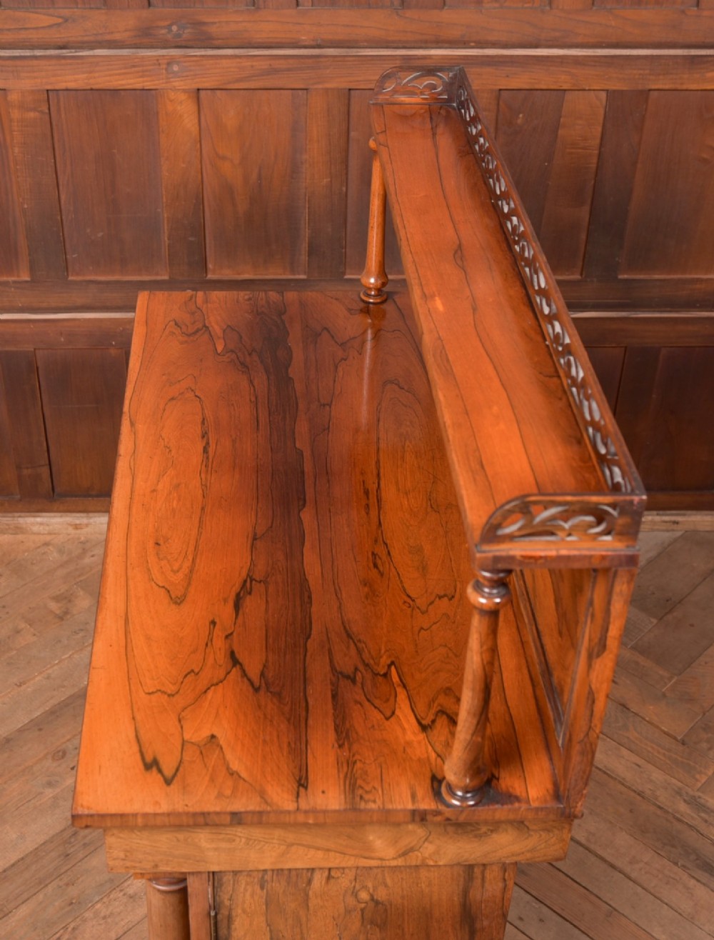 A Victorian rosewood chiffonier side cabinet featuring a raised back shelf with open fretwork gallery, turned columns, and a double-door cupboard base. View XII