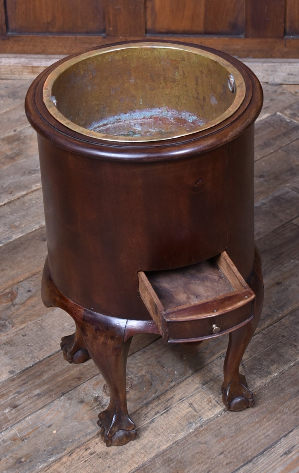 A cylindrical dark mahogany Victorian wine cooler with an internal brass liner, standing on four cabriole legs with ball and claw feet. View IV