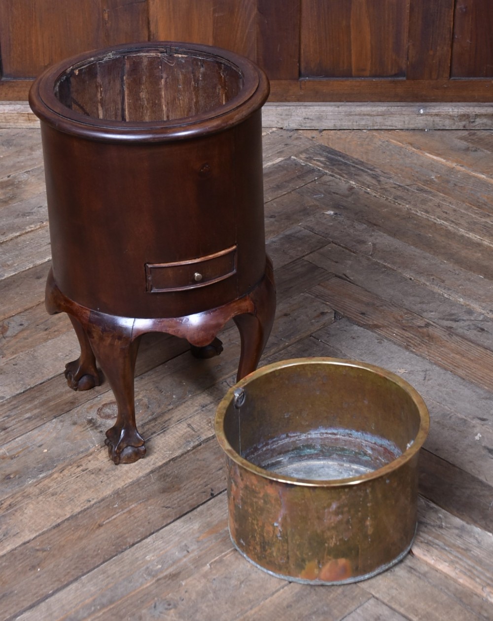 A cylindrical dark mahogany Victorian wine cooler with an internal brass liner, standing on four cabriole legs with ball and claw feet. View V