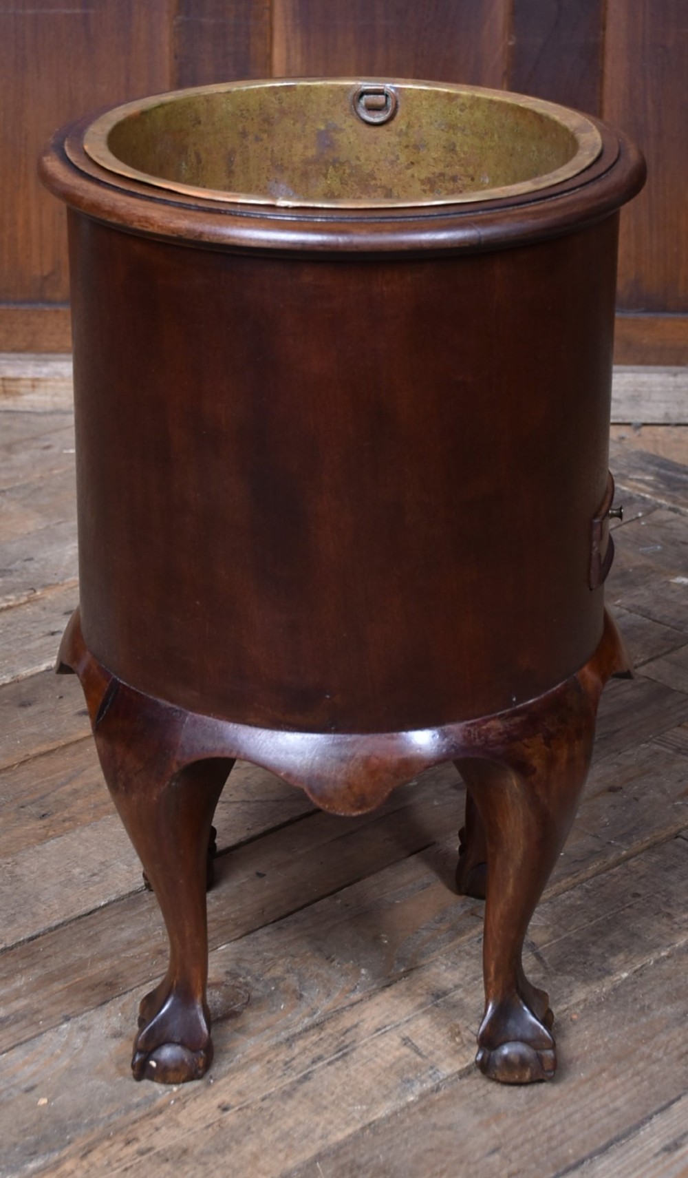 A cylindrical dark mahogany Victorian wine cooler with an internal brass liner, standing on four cabriole legs with ball and claw feet. View VIII