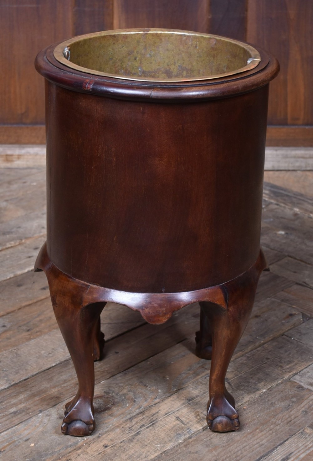 A cylindrical dark mahogany Victorian wine cooler with an internal brass liner, standing on four cabriole legs with ball and claw feet. View IX