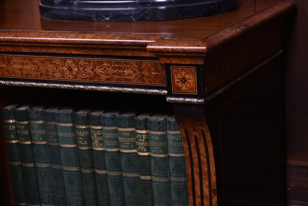 A low Victorian open bookcase featuring three sections of open shelving, rich amboyna wood veneer, ebonised borders, and delicate marquetry inlays. View II