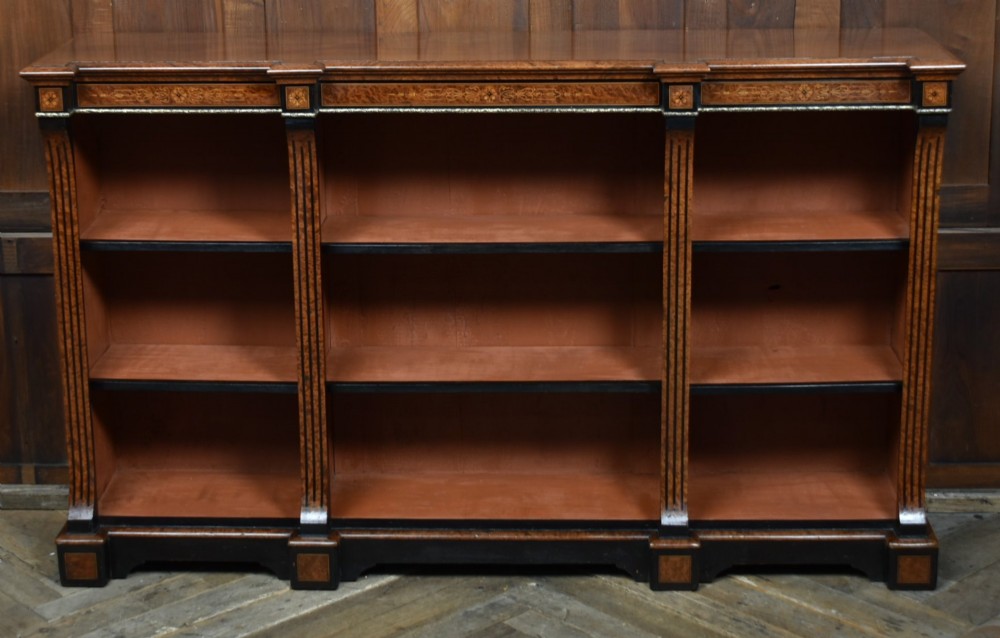 A low Victorian open bookcase featuring three sections of open shelving, rich amboyna wood veneer, ebonised borders, and delicate marquetry inlays. View III